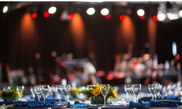 Table setting with glasses on the table and a soft background of a music stage